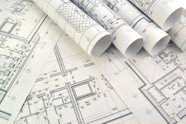 construction drawings spread out on table
